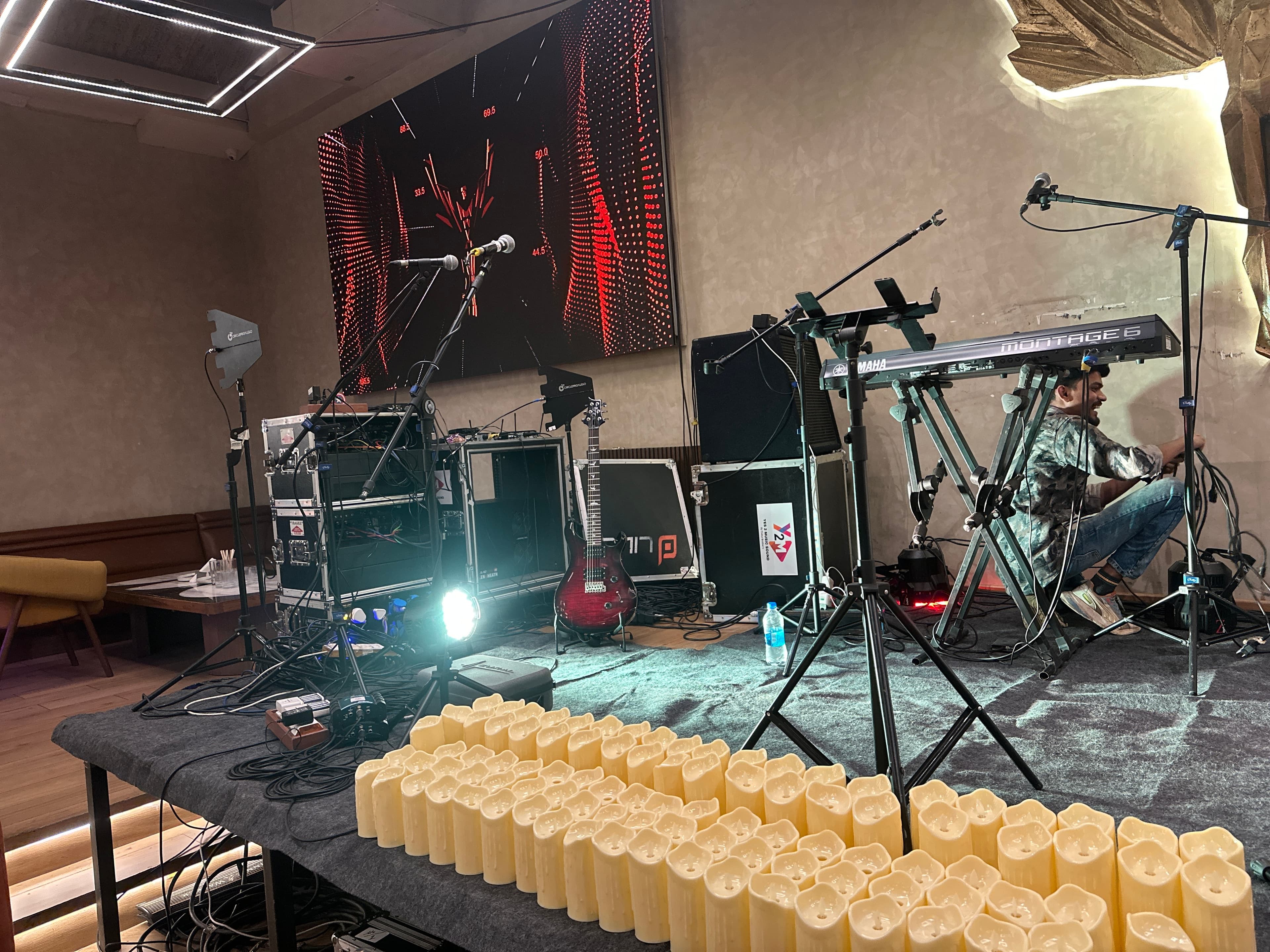 Indoor artist showcase setup with lighting and instruments.