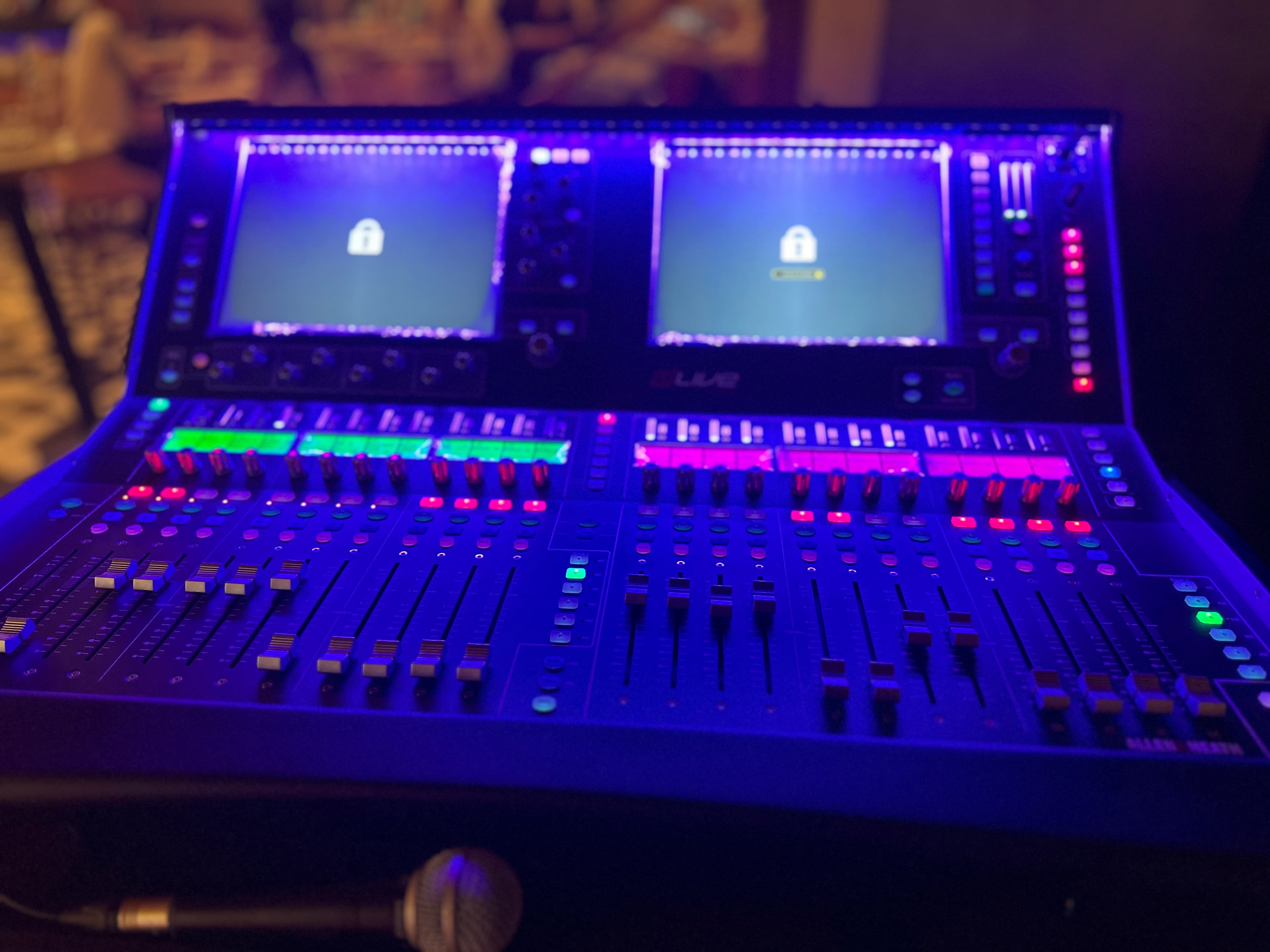 Blue-lit control surface in a dark session environment.