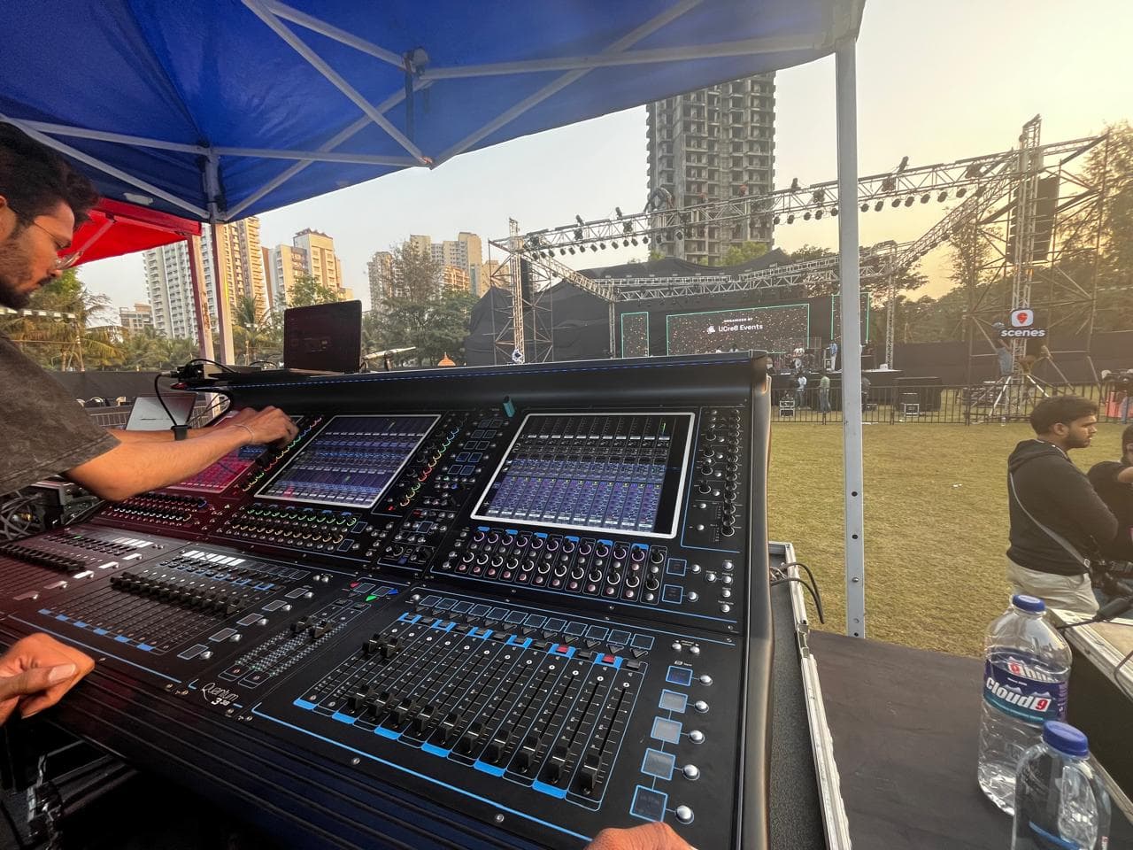 Front-of-house mixing console in action at an outdoor event.